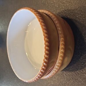 Two Bavarian orangebrown ceramic 6" wide, 2" deep pie forms, white interior.